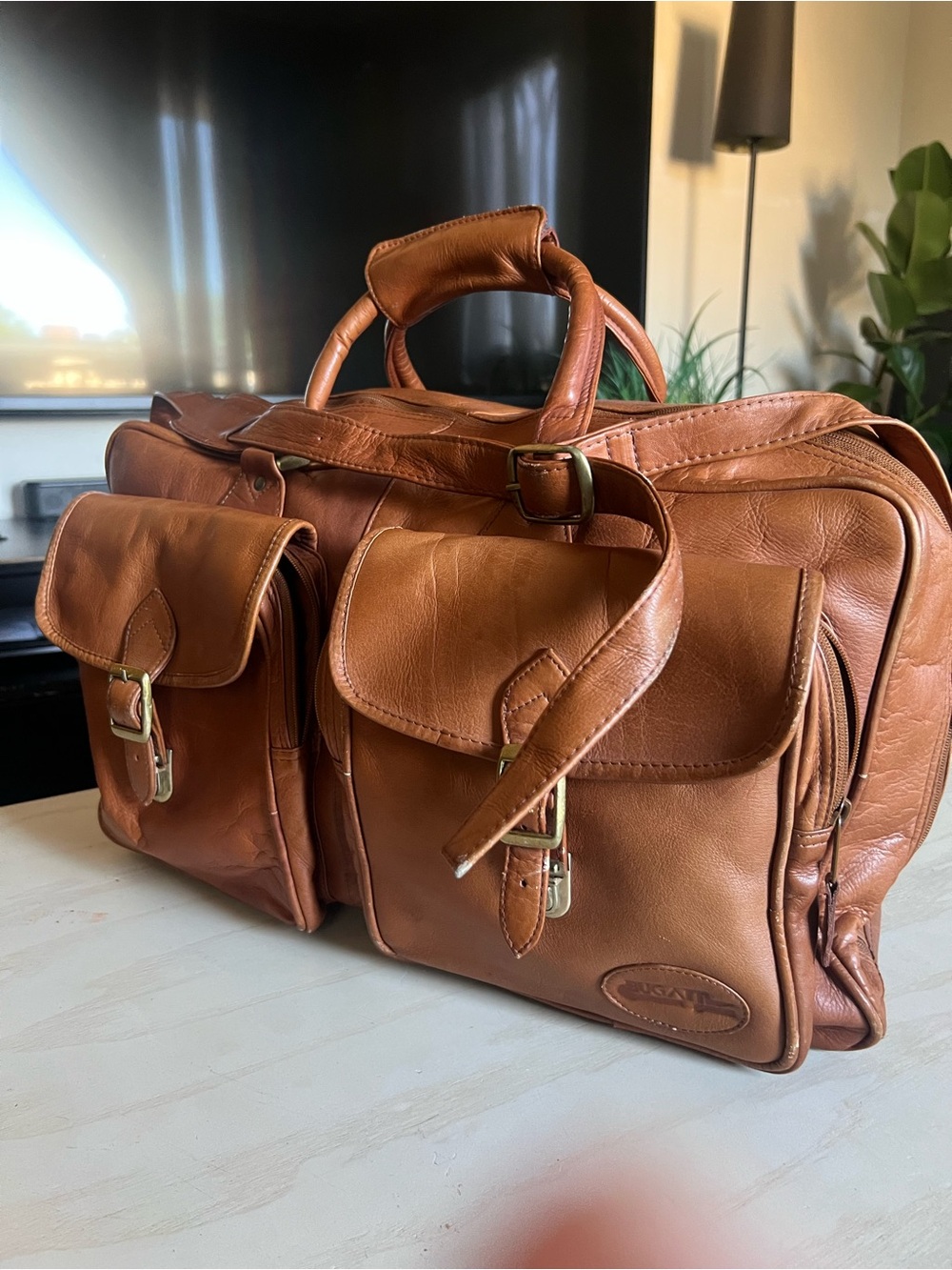 Bugatti Tan Leather Travel Bag with Front Buckle Pockets